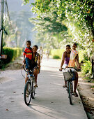 Kids riding their bikes to school, Anse La Reunion, La Digue, La Digue and Inner Islands, Republic of Seychelles, Indian Ocean