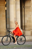 Woman cycling on an e-bike, bike tour, Schlossplatz, New Castle, Stuttgart, Baden-Wurttemberg, Germany