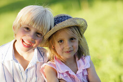 Sibling (5 and 7 years) smiling at camera, Lake Starnberg, Bavaria, Germany