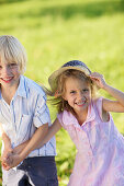 Sibling (5 and 7 years) smiling at camera, Lake Starnberg, Bavaria, Germany