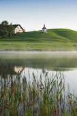 View over lake Hegratsried to chapel royal, Halblech, Allgaeu, Bavaria, Germany