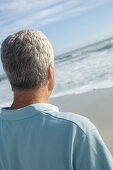 Man looking out to sea, rear view