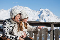 Mother and daughter on balcony at ski resort