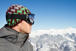 Portrait of young man with ski goggles, profile