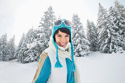 Young woman in winter clothes smiling at camera