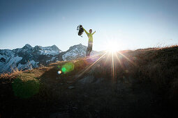 Hiker on the summit of Mottakopf, Schesaplana in the background, Brandner Valley, Vorarlberg, Austria