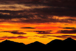 Clouds above silhouettes of Kampenwand, Hochplatte, Hochfelln and Hochgern at sunset, view from Lacherspitze, Wendelstein range, Bavarian alps, Upper Bavaria, Bavaria, Germany, Europe