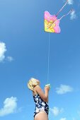 Six year old girl flying a kite at the beach  Mimiwhangata, Northland, New Zealand