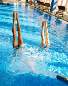 Couple doing a handstand in a hotel pool, spa resort, Travemuende, Luebeck, Schleswig-Holstein, Germany
