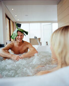 Couple in the hot tub, spa resort, Travemuende, Luebeck, Schleswig-Holstein, Germany