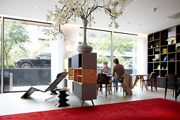 Guests in the lobby with designer furniture, Citizen M Hotel, Amsterdam, Netherlands