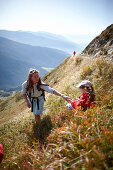 Mother and daughter in grass, Am Hochpillberg, Schwaz, Tyrol, Austria