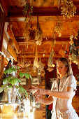 Woman at a tea bar in a herb room, Am Hochpillberg, Schwaz, Tyrol, Austria
