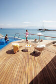 Man and woman in the pool and on the deck of the Yachting Club Villas, Elounda Beach Resort, Elounda, Crete, Greece