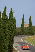 Vintage car on a country road at the Montalcino region, Tuscany, Italy, Europe