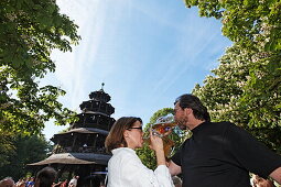 People enjoying a sunny day at the Chinesischer Turm beer garden, Englischer Garten, Munich, Upper Bavaria, Bavaria, Germany, Europe