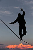 Young man balancing on a longline at sunset, Auerberg, Bavaria, Germany, Europe