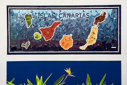 Strelitzia in front of a mosaic of the Canary Islands, Puerto de la Cruz, Tenerife, Canary Islands, Spain, Europe