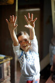 Girl showing sticky hands, Klein Thurow, Roggendorf, Mecklenburg-Western Pomerania, Germany