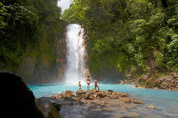 People in front of waterfall Rio Celeste, Tenorio National Park, Costa Rica, Central America, America