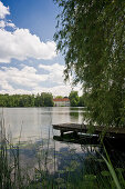 Hartmannsberg Castle and lake Schlosssee near Eggstaett, Chiemgau, Bavaria, Germany