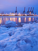Frozen Elbe river with Waltershof container terminal in the evening, Hanseatic City of Hamburg, Germany, Europe
