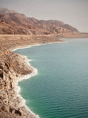Salt deposit along the shore of the Dead Sea and rough rocks, Jordan, Middle East, Asia