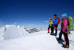 Drei Bergsteiger stehen am Gipfel des Piz Palü, Graubünden, Schweiz