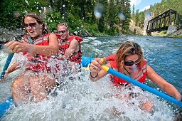 Jessica Florian, Jed Weber and Shannon Otto whitewater rafting the Cabarton section on the North Fork of the Payette River near the city of Cascade in central Idaho