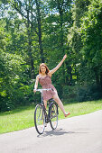 Pretty woman with bike in the park