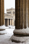 Snow-covered Koenigsplatz, bicyclist in front of Propylaen, view from Antikensammlung, Munich, Bavaria, Upper Bavaria, Germany