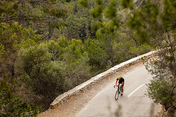 Bike racer on pass above Es Capdella, Mallorca, Spain