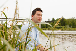 Young man on the Isar riverbank, Munich, Bavaria, Germany