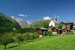 Church and traditional houses in front of the Bernese Alps, Ernen, valley of Binntal, Rhone valley, Valais, Switzerland