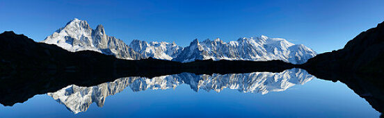 Panorama of Mont Blanc range reflecting in a mountain lake, Mont Blanc range, Chamonix, Savoy, France