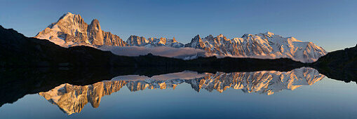 Panorama of Mont Blanc range reflecting a in mountain lake, Mont Blanc range, Chamonix, Savoy, France