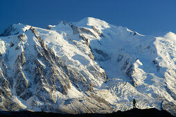 Woman hiking in front of Mont Blanc, Mont Blanc range, Chamonix, Savoy, France