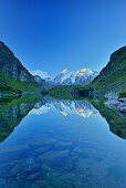 Grand Combin, Combin de Corbassiere and Petit Combin reflecting in mountain lake, Pennine Alps, Valais, Switzerland