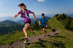 Trailrunning, Trail running, Trail, Ramsau, Dachstein, Styria, Austria, couple, woman, man, meadow, running, walking, run, mountains, mountain run, dog jogging, sport, fitness, health,. Trailrunning, Trail running, Trail, Ramsau, Dachstein, Styria, Austri