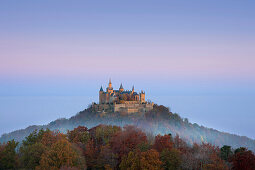 View to Hohenzollern castle in morning mist, near Hechingen, Swabian Alb, Baden-Wuerttemberg, Germany