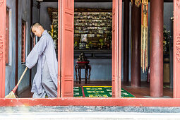 Young monk at the tomb of the emperor Thien Mu, near the Imperial city of Hue, Vietnam, Asia