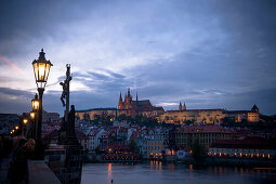 Charles bridge at dusk with view of the old town of Prague, Prague, Czech Republic
