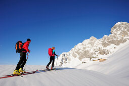 Two backcountry skiers ascending to hut Gruttenhuette, Kaiser-Express, Rote-Rinn-Scharte, Wilder Kaiser, Kaiser mountain range, Tyrol, Austria