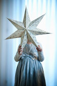 Girl  holding a Christmas star, Styria, Austria