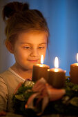 Girl (4 years) looking at an Advent wreath