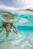 Girl diving in bay Cala S Amonia, Mallorca, Balearic Islands, Spain