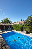 Two girls swimming in a pool, Finca, Algaida, Mallorca, Balearic Islands, Spain