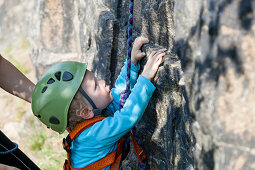 Boy (2 years) climbing in a quarry near Leipzig, Saxony, Germany