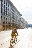 Cyclist passing street Maximilianstrasse, Munich, Bavaria, Germany