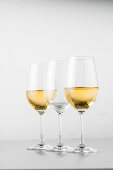 Two glasses of white wine and an empty glass, Hamburg, Northern Germany, Germany